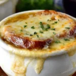 French Onion Soup Recipe Gluten Free served in a white bowl with golden cheese and crispy gluten-free bread on top