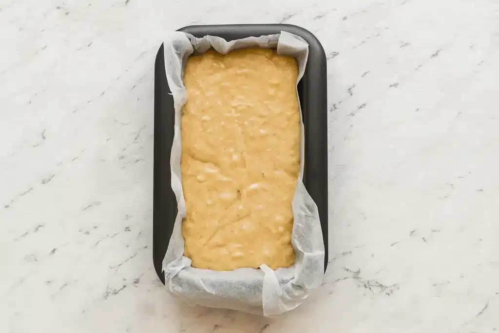 Gluten-free eggless banana bread batter poured into a loaf pan before baking