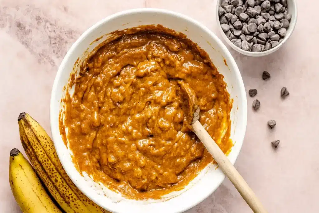 Gluten free pumpkin banana bread batter in bowl with chocolate chips